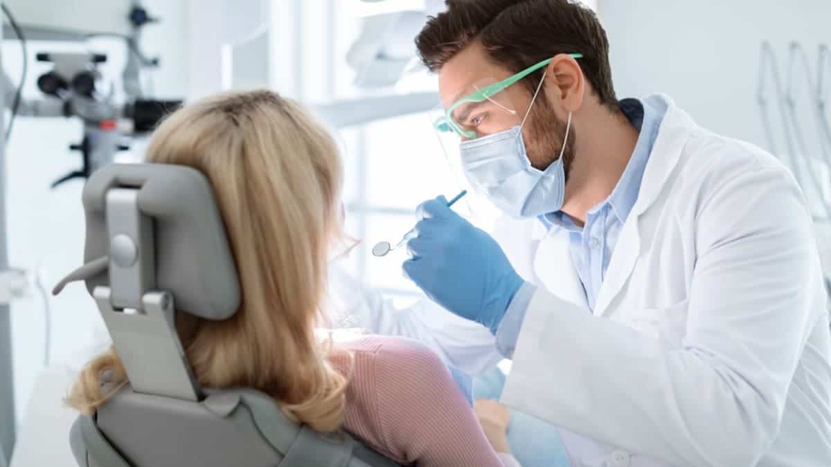 Patient receiving professional teeth whitening with a laser device Grimsby